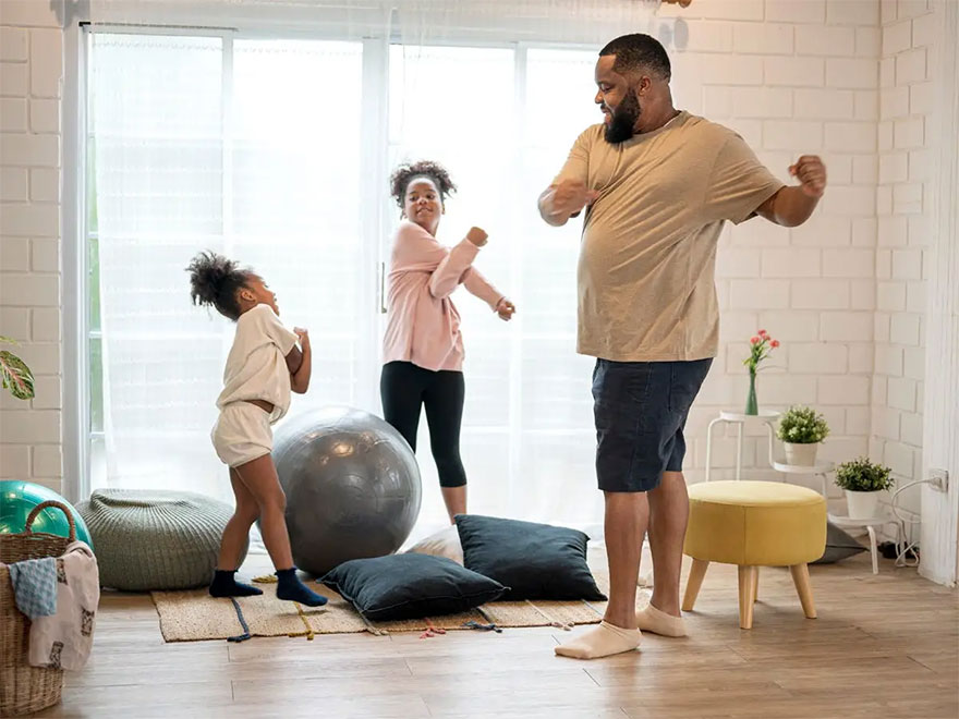 African father and his two daughter morning exercise at home.